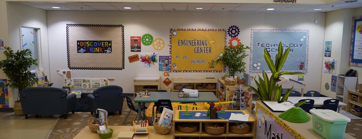 A STEAM room with "STEAM" on the wall, and math, art, science, technology, and engineering centers.