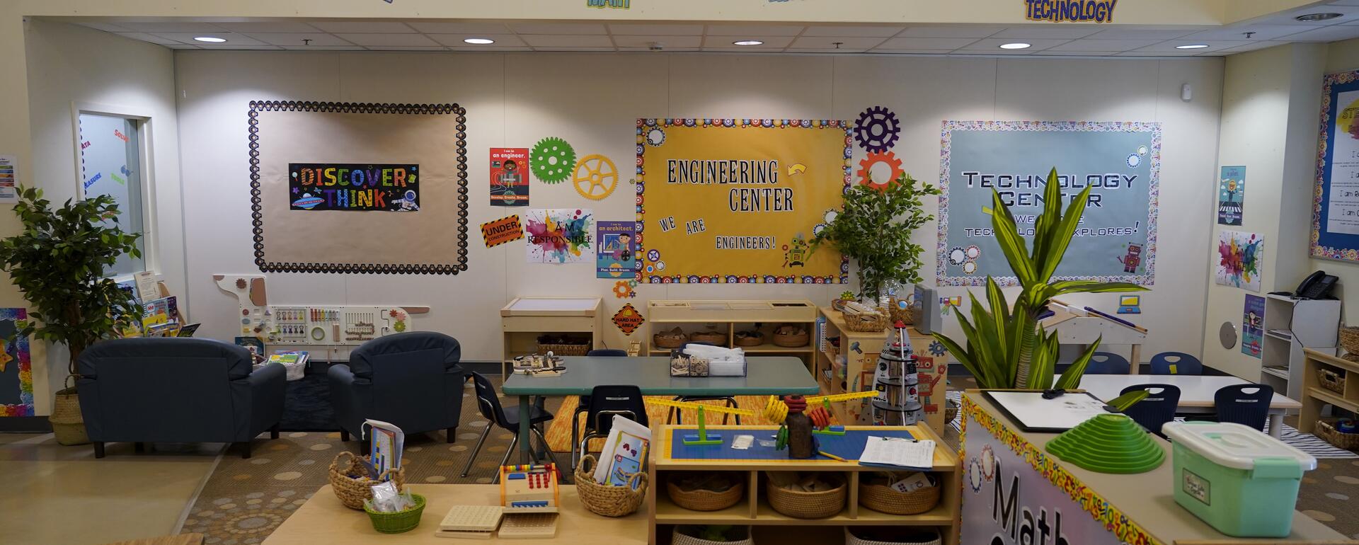 A STEAM room with "STEAM" on the wall, and math, art, science, technology, and engineering centers.
