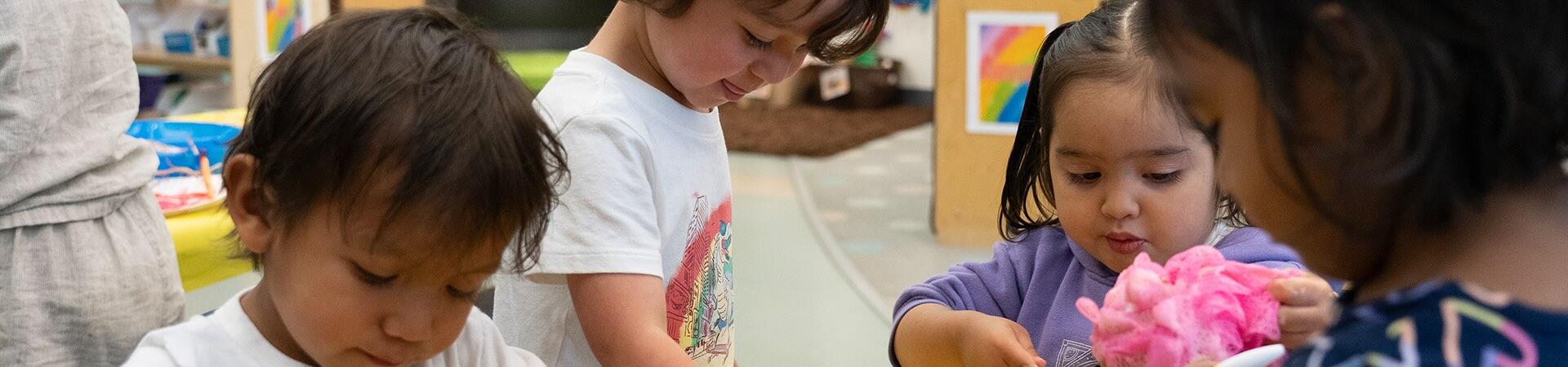 Students play with buckets of water and soap.